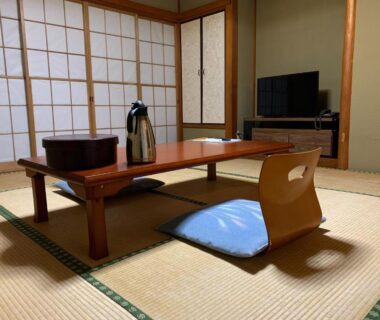 Tatami room with low table, zabuton cushion, shoji screens, TV and kettle at Manten-no-Hoshi Kanagawa Kantō Japan