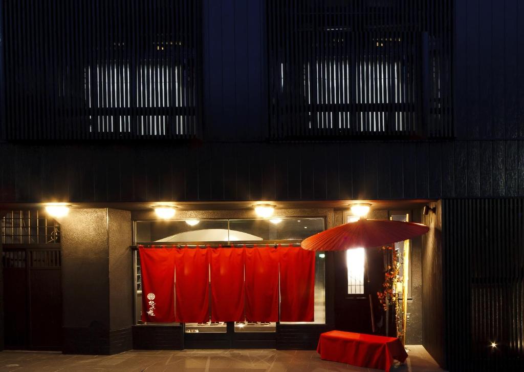 Red noren entrance Manten-no-Hoshi Kanagawa Dimly lit ryokan entrance with red noren curtains and lantern at Manten-no-Hoshi in Kanagawa