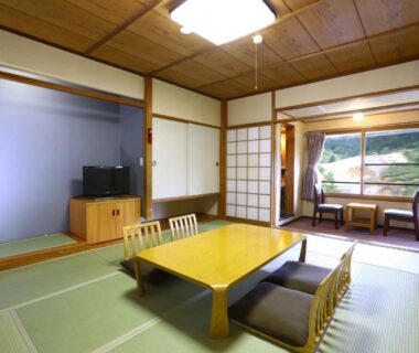 Traditional tatami room with low table and shoji screens at Manza Onsen Nisshinkan in Gunma, Kantō