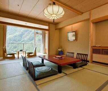 Tatami room with low table and mountain view at Marumine Kanko Hotel Fukushima