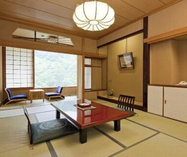 Tatami room with low lacquer table, shoji screens and window seating at Marumine Kanko Hotel, Fukushima