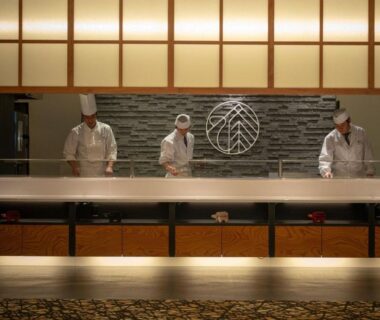 Three chefs preparing meals behind counter at Marumine Kanko Hotel in Fukushima, Tōhoku, Japan