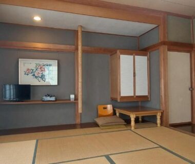 Traditional tatami guest room with low table, shoji screens and painted sliding doors at Masugataya Ryokan in Chiba Kanto