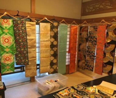 Colorful kimono obi sashes hanging in tatami room with shoji screens at Masugataya Ryokan, Chiba, Kantō