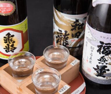 Wooden masu tray with glass cups and sake bottles at Masuya Ryokan, Nagano
