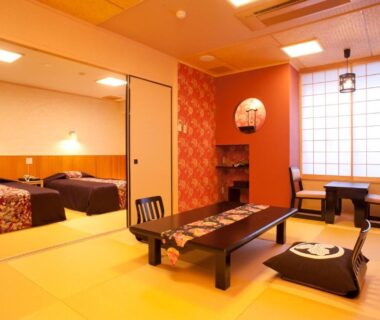 Tatami sitting area with low table, shoji screens and adjoining twin bedroom at Matsui-Bekkan Hanakanzashi, Kyoto