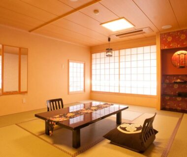 Traditional tatami room with low dining table, zabuton cushions, shoji screens and decorative alcove at Matsui-Bekkan Hanakanzashi Kyoto