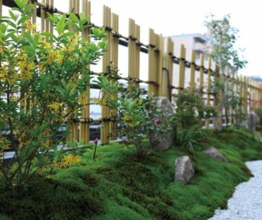 Low moss garden with gravel path and bamboo fence at Matsui-Bekkan Hanakanzashi in Kyoto
