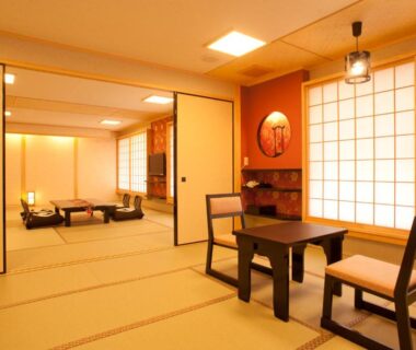 Spacious tatami room with low table, shoji screens and seating at Matsui-Bekkan Hanakanzashi in Kyoto