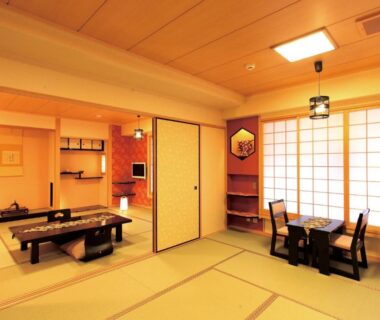 Spacious tatami room with low table, shoji screens and seating area at Matsui Honkan in Kyoto