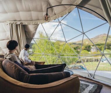 Seating area inside geodesic dome overlooking valley at Matsukaneya Annex in Yamagata prefecture