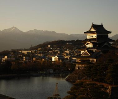 Dusk lakeside castle silhouette beside Matsumoto Jujo in Nagano Prefecture