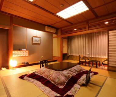 Traditional tatami room with kotatsu, shoji screens and low seating at Matsunoi ryokan in Gifu, Chūbu