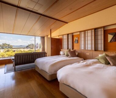 Spacious room with two beds, shoji screens and large window at Matsushima Ichinobo, Miyagi Tohoku