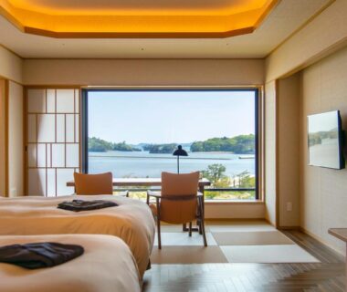 Tatami seating and twin beds facing a water view at Matsushima Ichinobo, Miyagi, Tōhoku