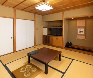 Traditional tatami room with low table, shoji doors and tokonoma at Matsushima Koumura in Miyagi