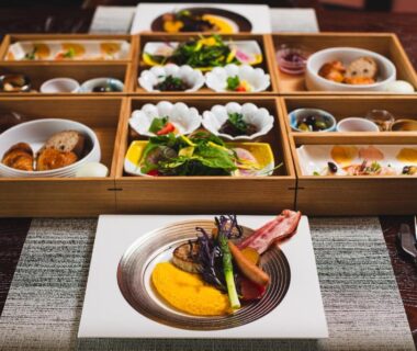 Assorted small Japanese dishes and plated seafood course on a lacquered table at Mayu Futahari Shizuoka