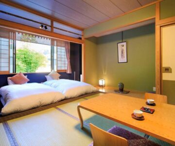 Tatami room with futon, low table and shoji screens at Meitoya So, Yamagata, Tōhoku, Japan