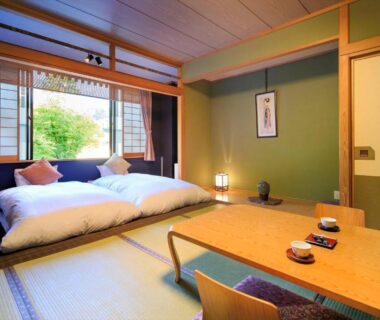 Tatami room with futon, low table and shoji screens at Meitoya So, Yamagata, Tōhoku, Japan