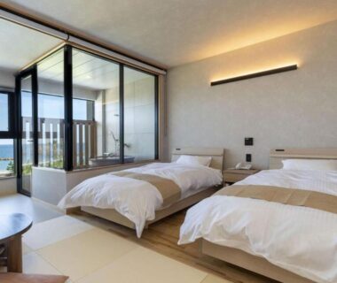 Twin beds on tatami floor with glass balcony doors at Michishio, Mie, Kansai