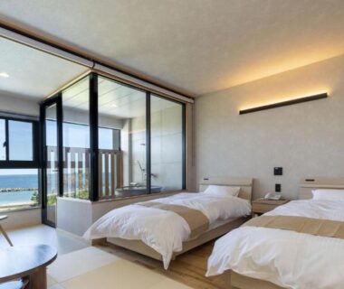 Twin beds on tatami with glass veranda overlooking the sea at Michishio in Mie, Kansai region