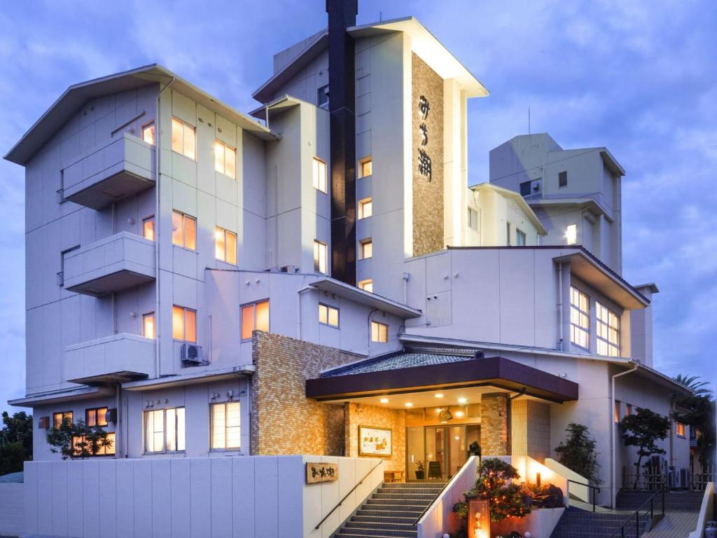 Exterior view Michishio Ryokan Mie Japan Lit entrance and multi-story facade of Michishio with balconies, Mie Prefecture, Kansai, Japan