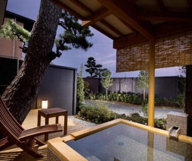 Wooden onsen bath on a deck with garden view at Migiwaya, Shizuoka, Chūbu