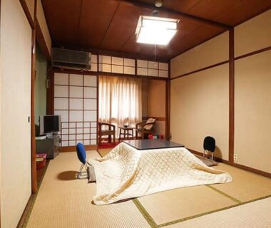 Tatami room with kotatsu and shoji screens at Migumiya Ryokan in Hyōgo, Kansai