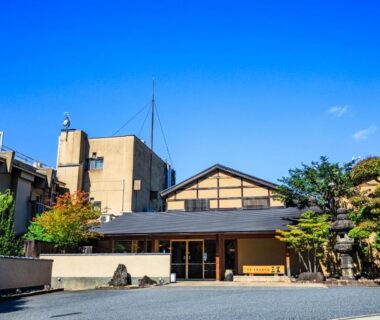 Ryokan entrance with traditional facade, courtyard and trees at Mikasa in Nara, Kansai