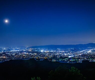 Moonlit city lights and distant hills over a valley near Mikasa ryokan, Nara in Kansai Japan