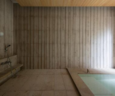Serene indoor wooden onsen bath with tiled floor and soaking tub at Mikuniya in Hyōgo, Kansai