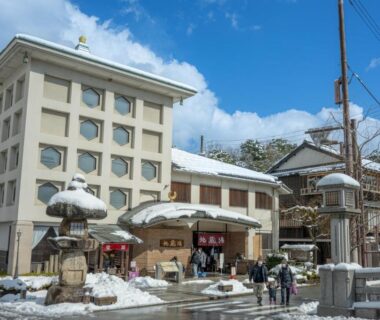Exterior street view of Mikuniya with snow-covered roofs and pedestrians in Hyōgo, Kansai