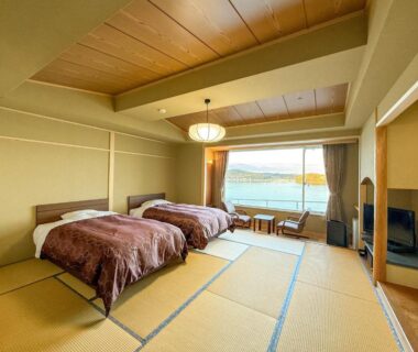 Tatami room with two beds and balcony overlooking the bay at Minami Sanriku Hotel kanyo, Miyagi