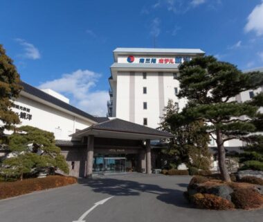 Main entrance and canopy with landscaped pine trees, exterior of Minami Sanriku Hotel kanyo in Miyagi, Tōhoku, Japan