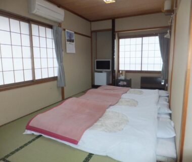 Traditional tatami room with futons at Minshuku Iwatakan in Gifu, Chūbu, Japan