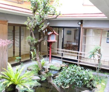 Small traditional courtyard pond and wooden veranda at Minshuku Katsuya, Wakayama, Kansai, Japan