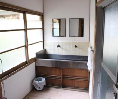 Traditional wooden vanity with stainless basin, shoji window, sliding door and towel rack inside Minshuku Katsuya, Wakayama