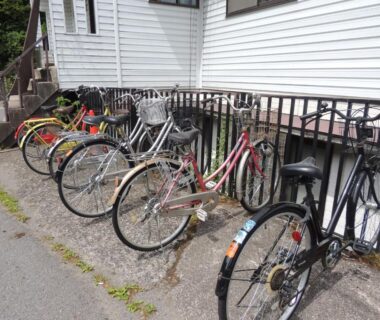 Bicycles parked along white building at Minshuku Kawarabi-so in Nara, Kansai