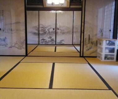 Traditional tatami room with painted fusuma panels and shoji screens at Minshuku Kitamaebune in Ishikawa