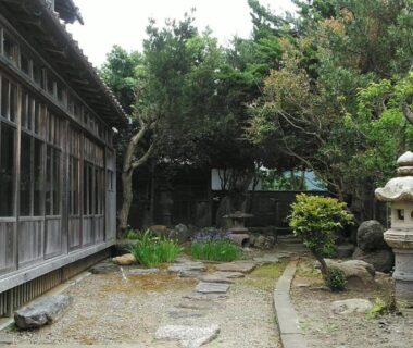 Gravel courtyard with stone lantern and stepping stones at Minshuku Kitamaebune, Ishikawa