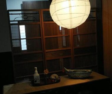 Round paper lantern above wooden counter at Minshuku Kitamaebune, Ishikawa, Chūbu Japan