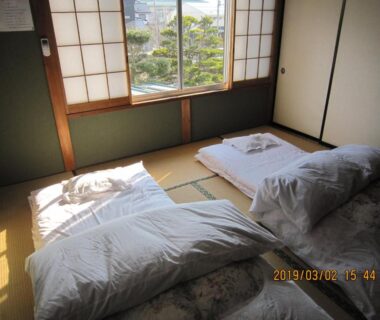 Tatami room with futon bedding, shoji screens and garden view in Yamanashi