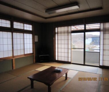 Traditional tatami room with low table, shoji screens and sliding doors at Minshuku Kobayashi in Yamanashi, Chūbu, Japan
