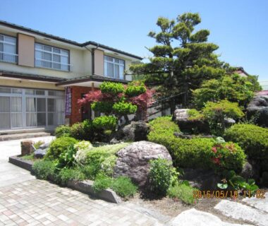 Manicured rock garden with pruned pine outside Minshuku Kobayashi in Yamanashi, Chūbu, Japan