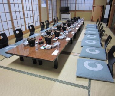 Tatami dining room with low tables, shoji screens and floor cushions at Minshuku Kobayashi, Yamanashi