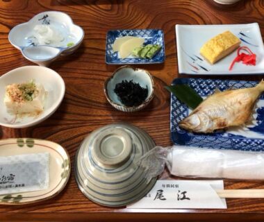 Assorted Japanese meal dishes on wooden table at Minshuku Oe, Kyoto, Kansai, Japan