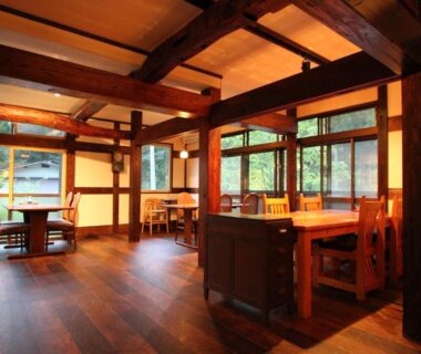 Communal wooden dining area with large windows at Minshuku Takizawa in Chūbu, Gifu, Japan