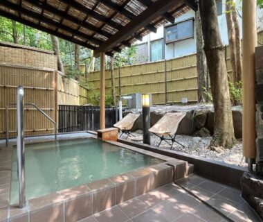 Covered outdoor onsen bath with bamboo fencing and stone details at Mitake, Kanagawa, Kantō, Japan