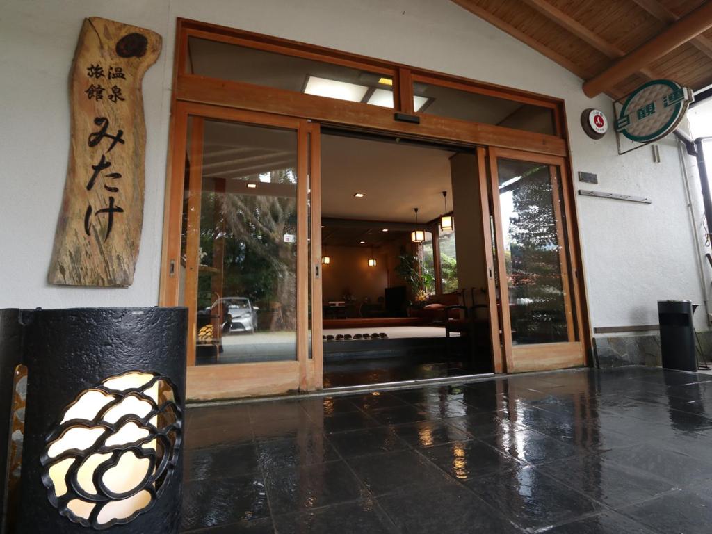 Ryokan entrance Mitake Kanagawa Japan Polished stone entry with wooden sliding doors and Mitake signboard at a Kanagawa ryokan
