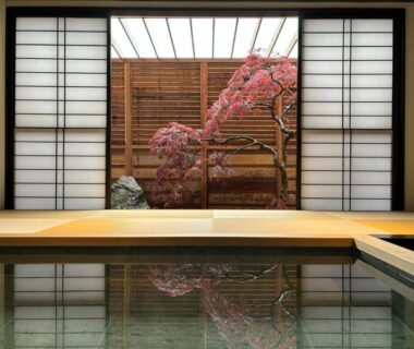 Indoor onsen bath with shoji screens and maple tree view at Miyahama Grand Hotel, Hiroshima